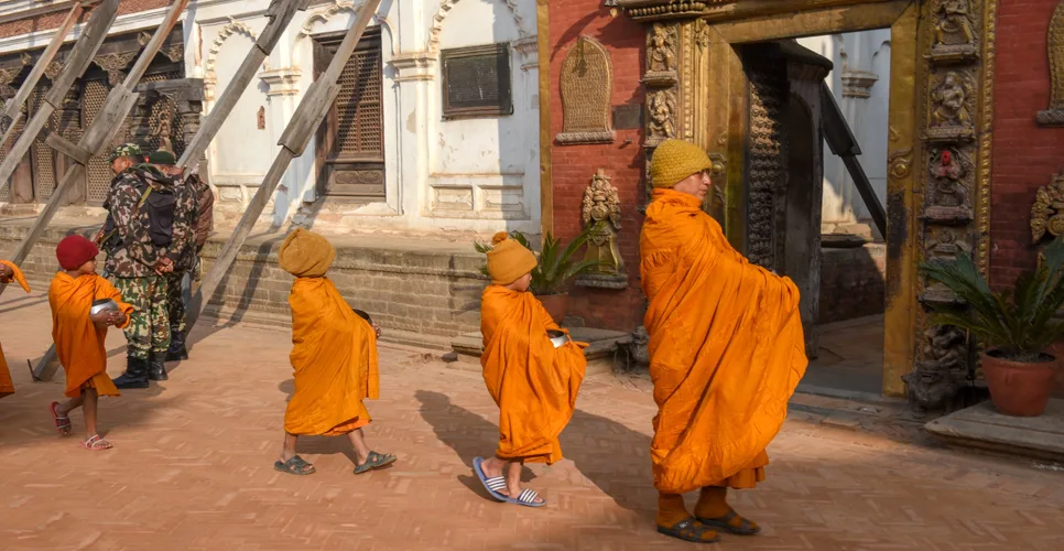 Young Buddhist monks walking in morning alms at Bhaktapur